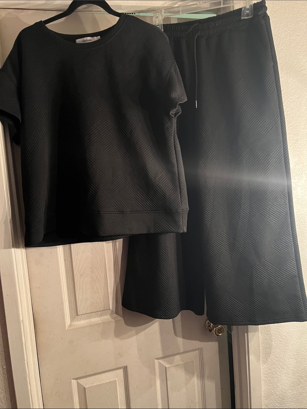 Black Quilted shirt and wide legged pants.